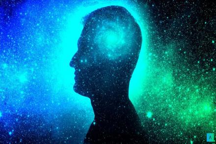 Silhouette of a man superimposed over the cosmos with the swirl of the universe where his brain would be.